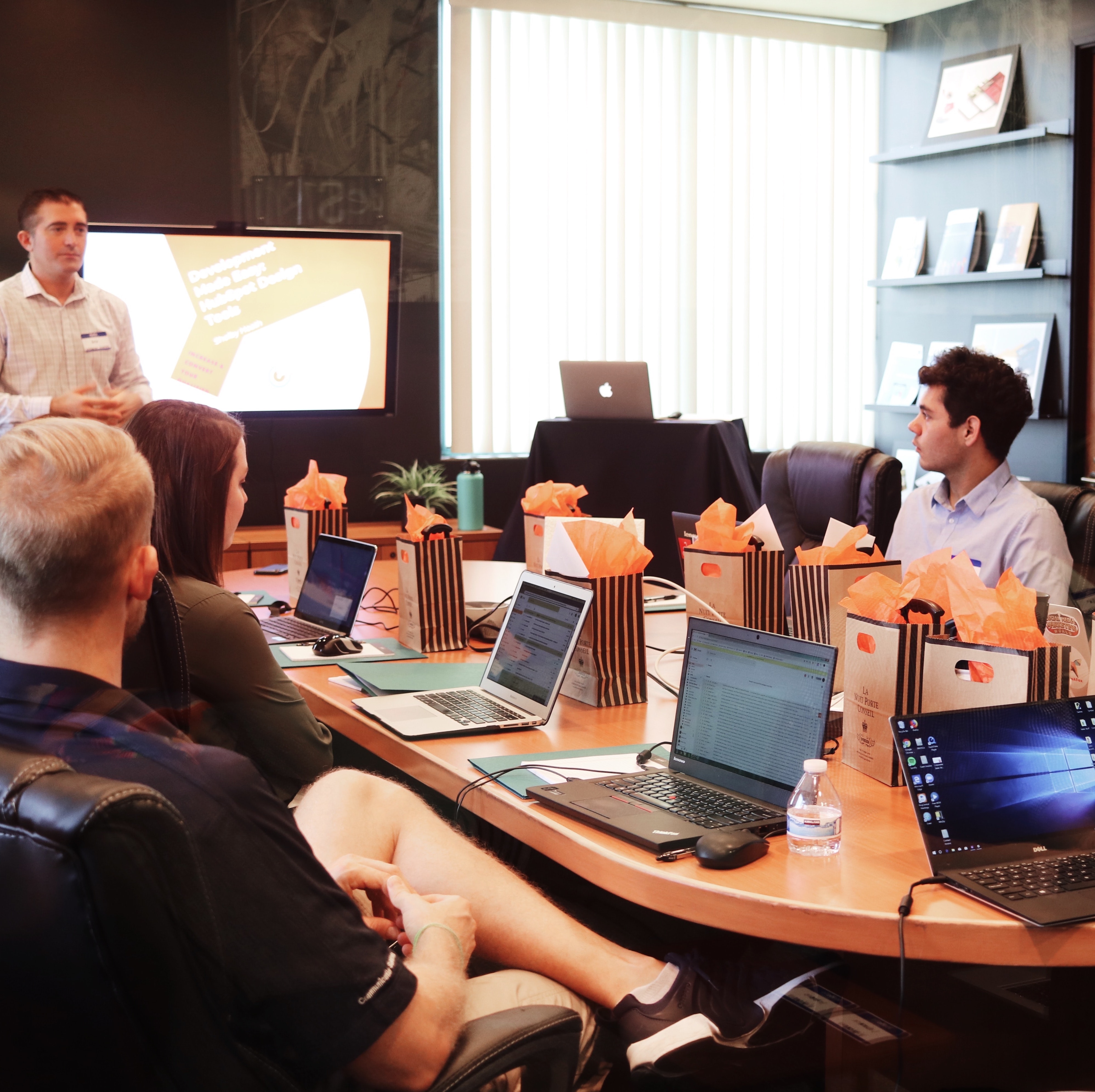 Group of people training at a company, seated around a table